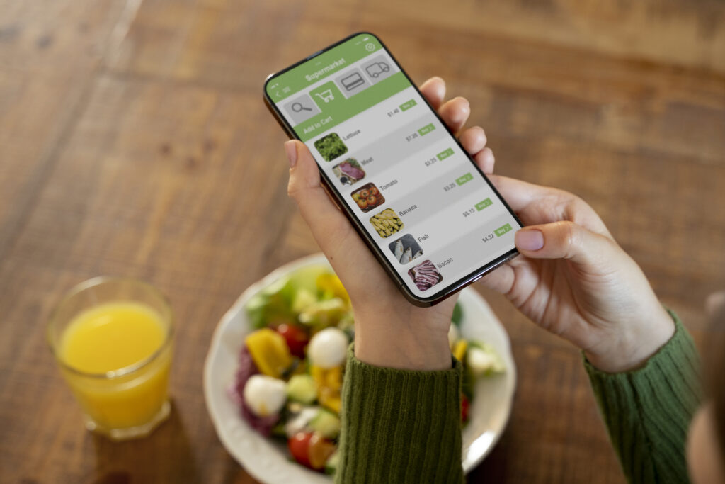 woman buying fruits online using her smartphone