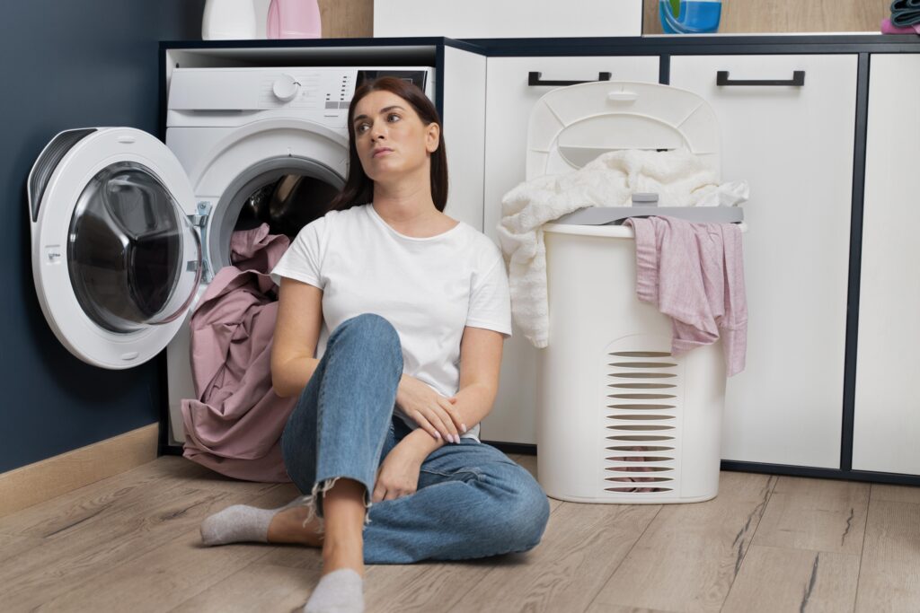 woman looking tired after doing laundry